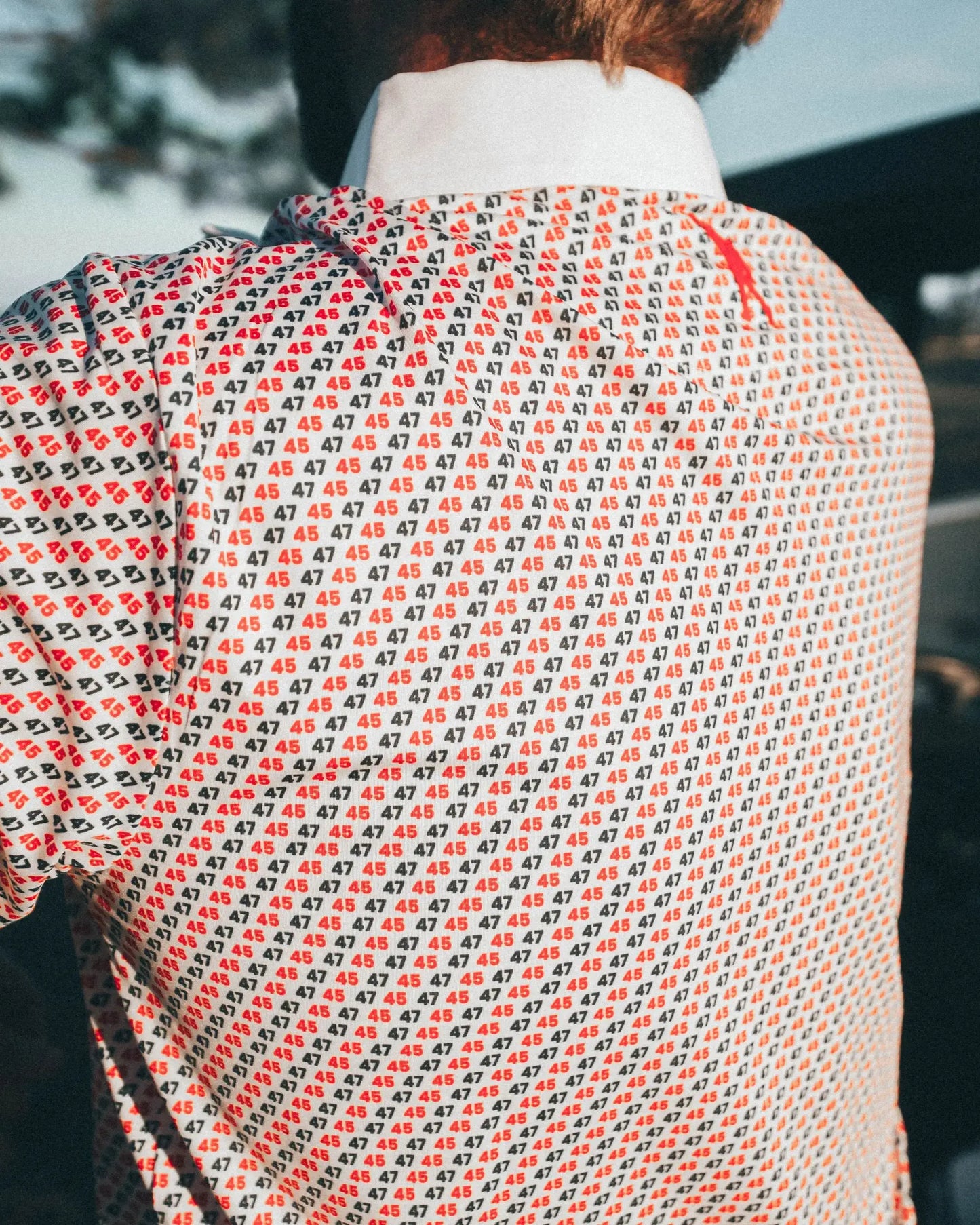 Back view of 45 47 polo shirt with red and navy 45/47 pattern by Haven Golf, showcasing subtle patriotic style and comfort.