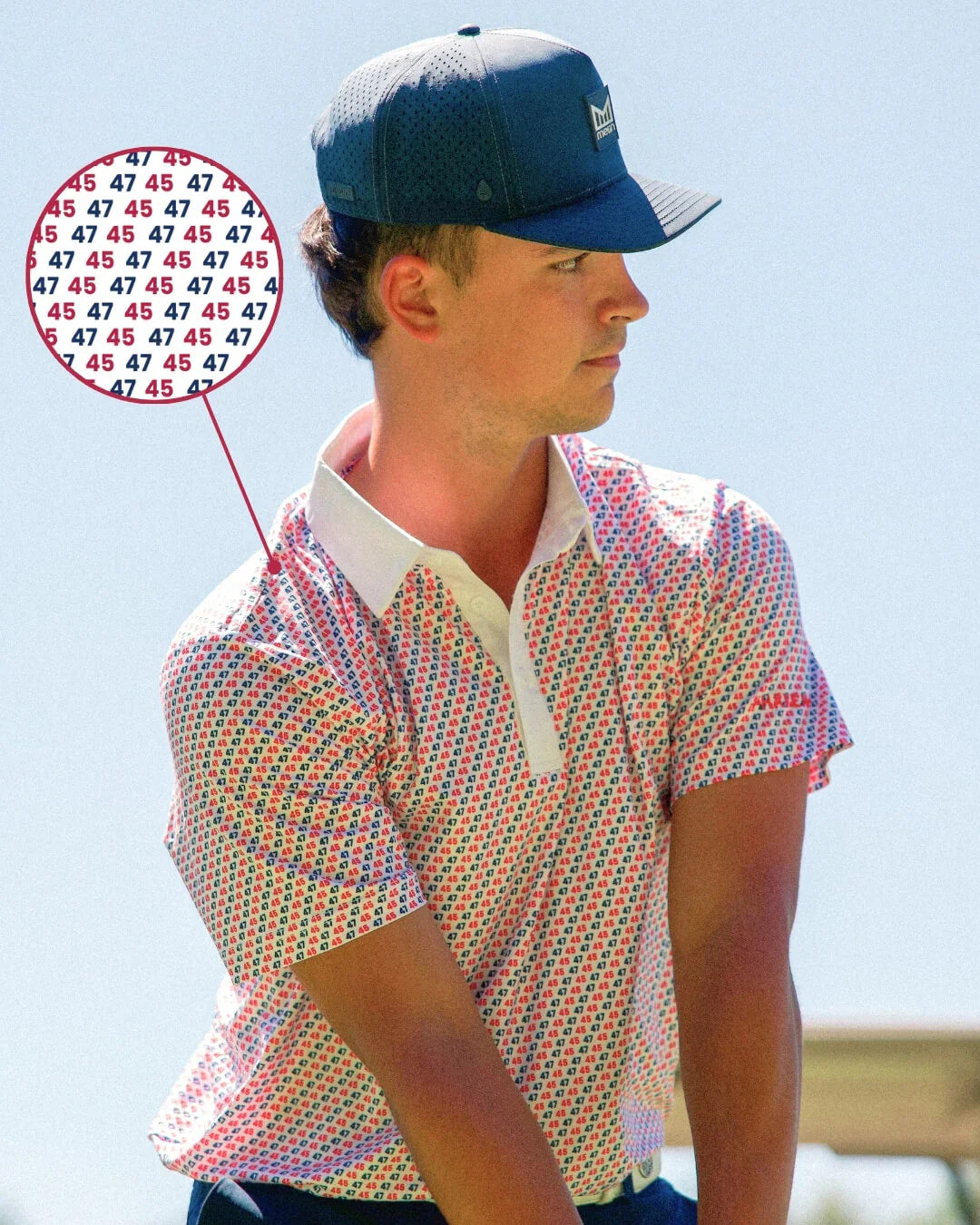 Man wearing 47 45 freedom polo shirt with patriotic design and hat outdoors.