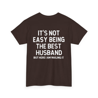 Not Easy Being the Best Husband Shirt – Funny husband tee with humorous text on a dark brown cotton t-shirt.