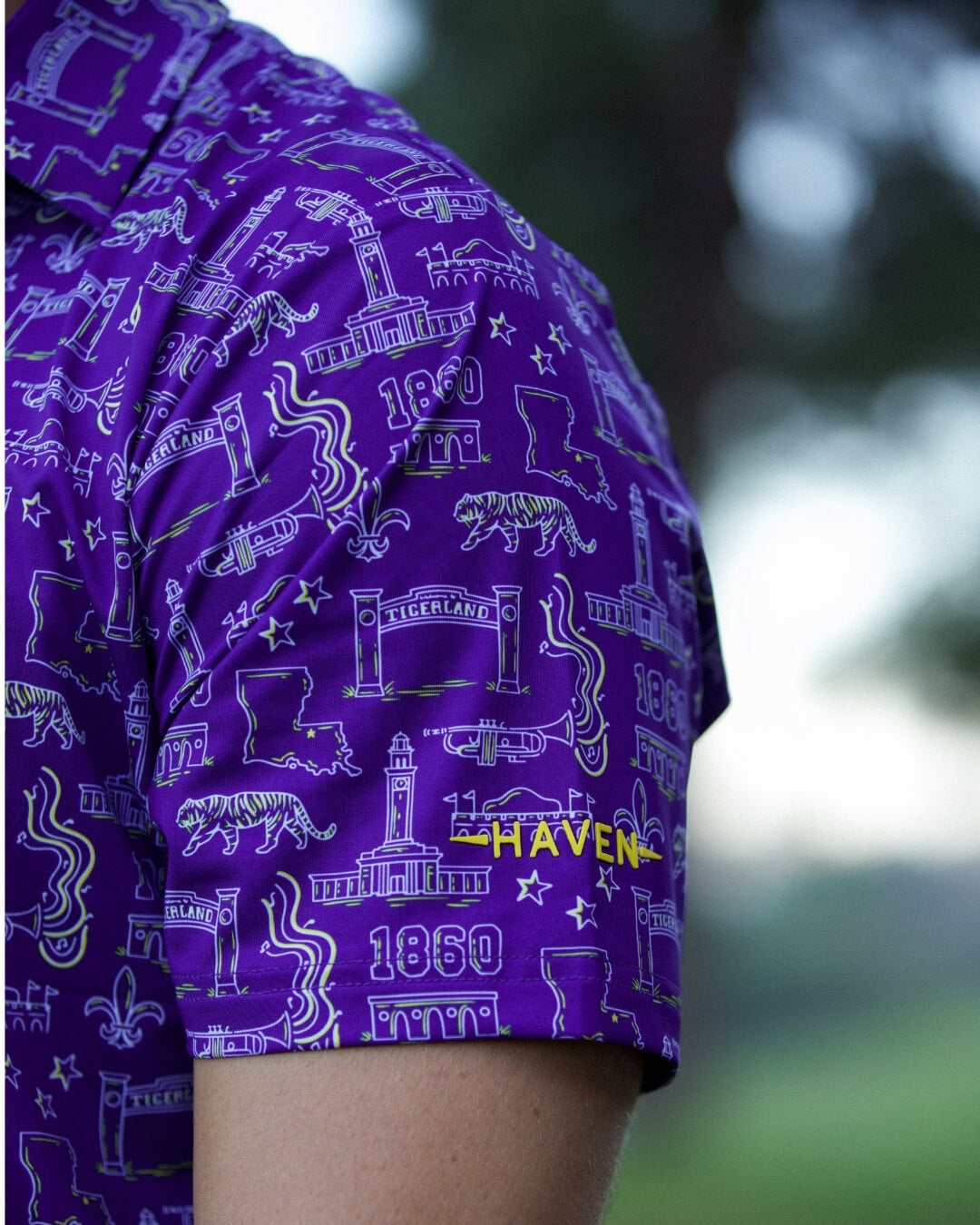 Close-up of Baton Rouge football polo shirt by Haven Golf featuring bold Louisiana-inspired design and "Play Neck" chant details.