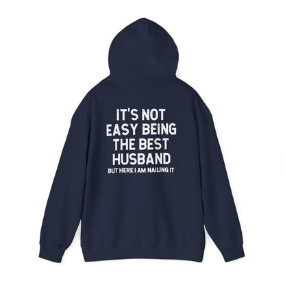 Best Husband Hoodie featuring the phrase 'It's Not Easy Being THE BEST HUSBAND But Here I Am Nailing It' on back.