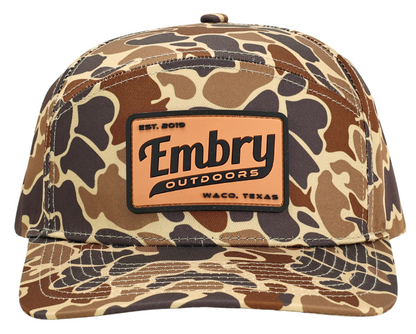 Front view of Duck Camo 6 Panel "Retro" Trucker hat with Embry Outdoors logo, featuring a unique camo pattern made from 100% polyester.