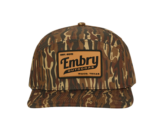 Brown Ranch Camo Trucker Hat with camo pattern and logo on front panel, perfect for outdoor activities and casual wear.