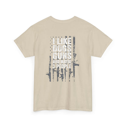 I Like Dogs Guns and Maybe 3 People T-Shirt with humorous graphic and text on beige background.