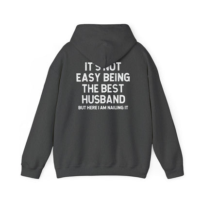 Best Husband Hoodie featuring bold back text: "It's Not Easy Being The Best Husband But Here I Am Nailing It"