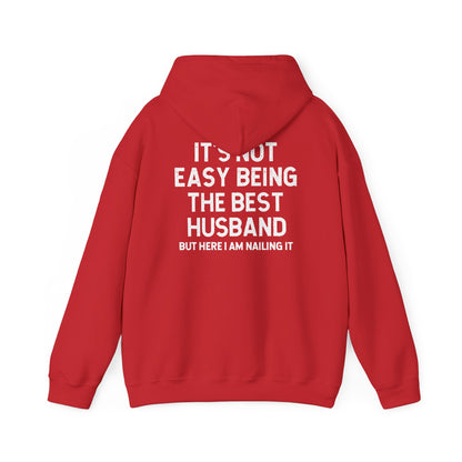 Best Husband Hoodie in red with white text stating 'It's Not Easy Being THE BEST HUSBAND BUT HERE I AM NAILING IT'.