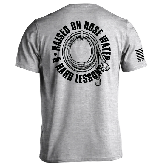 Back view of Raised On Hose Water & Hard Lessons Shirt featuring hose and flag design.