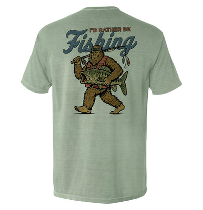 I’d Rather Be Fishing Bigfoot Shirt with humorous fishing and Bigfoot design on tee.