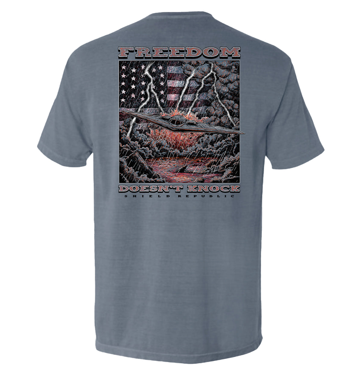 Freedom Doesn’t Knock Shirt featuring patriotic graphic and dramatic stormy backdrop, highlighting strength and independence.