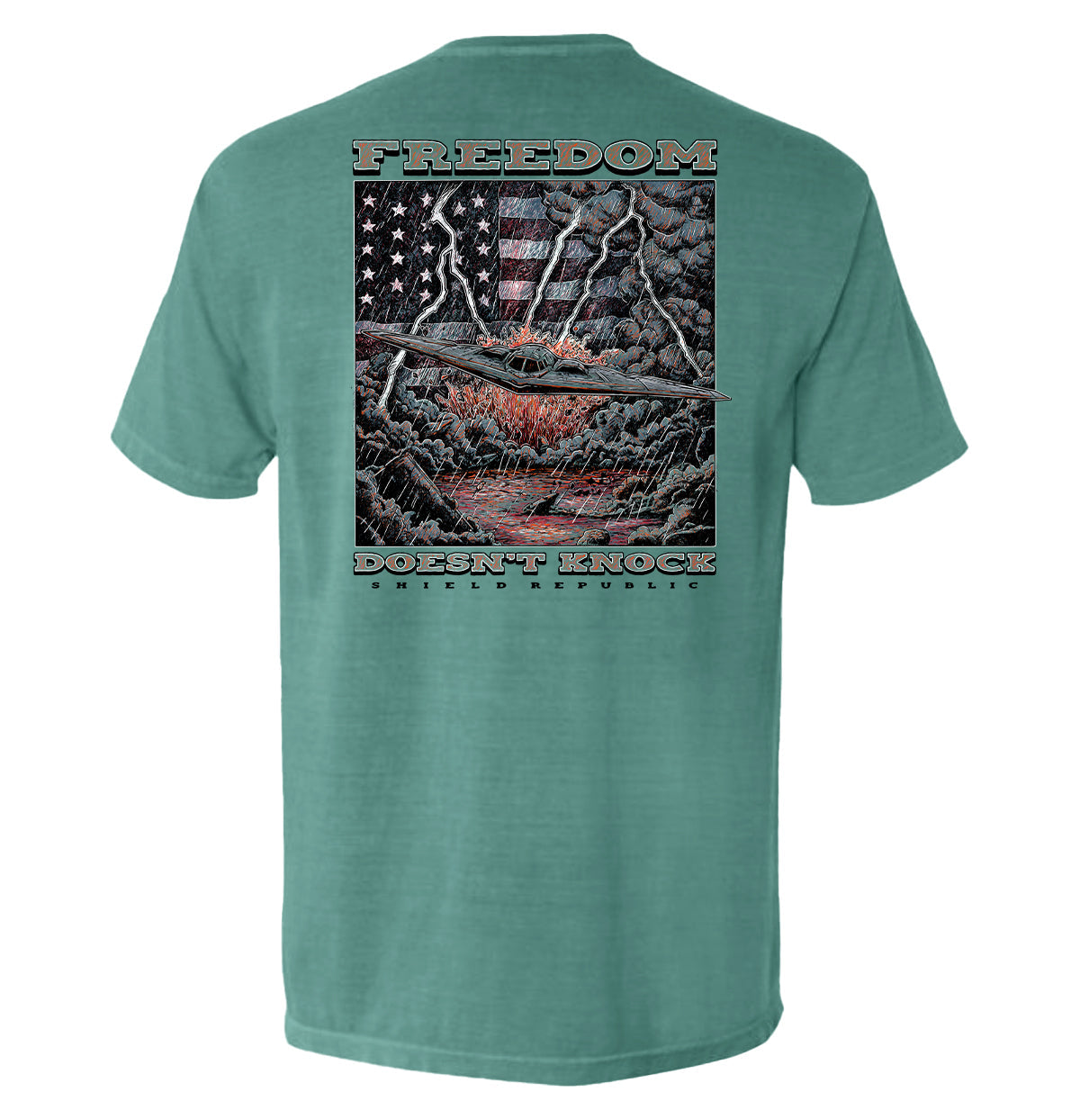 Freedom Doesn’t Knock Shirt with stormy sky and patriotic elements graphic on back, expressing strength and independence.