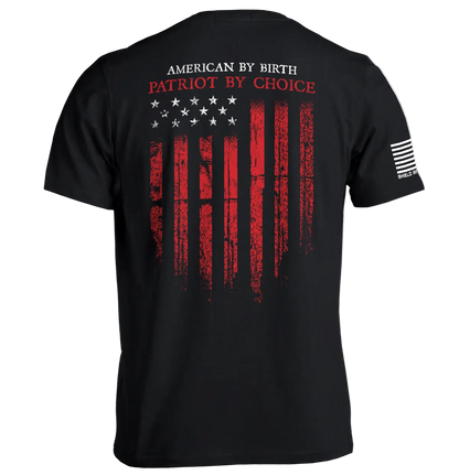Patriot shirt American flag tee with distressed flag and "American By Birth, Patriot By Choice" slogan on back view.