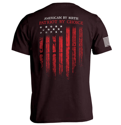 Patriot shirt American flag tee with distressed red and white flag graphic and 'American By Birth, Patriot By Choice' message.