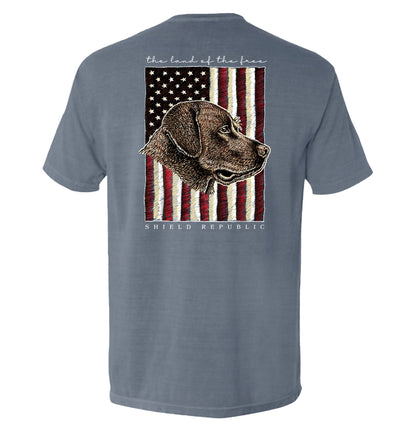 The Land of the Free Chocolate Lab Dog T-Shirt with American flag and chocolate Labrador illustration, patriotic dog tee design.