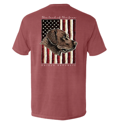 The Land of the Free Chocolate Lab Dog T-Shirt with vintage dog and American flag design, patriotic apparel