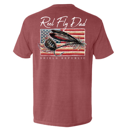 Reel Fly Dad Fishing American Flag T-Shirt with fly fishing graphic and Shield Republic logo on red tee