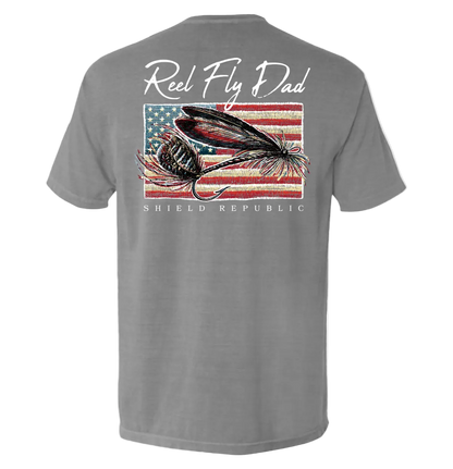 Reel Fly Dad Fishing American Flag T-Shirt featuring fly fishing design and Shield Republic logo on a gray background