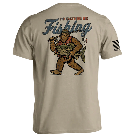 Beige t-shirt with a graphic of a bear holding a fish and text 'I'd Rather Be Fishing' on the back.