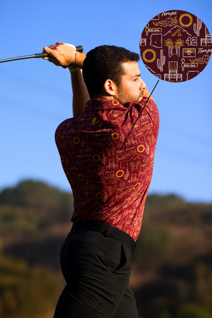 Man wearing Tempe football polo shirt "The Inferno" with bold design, swinging a golf club under clear blue sky.