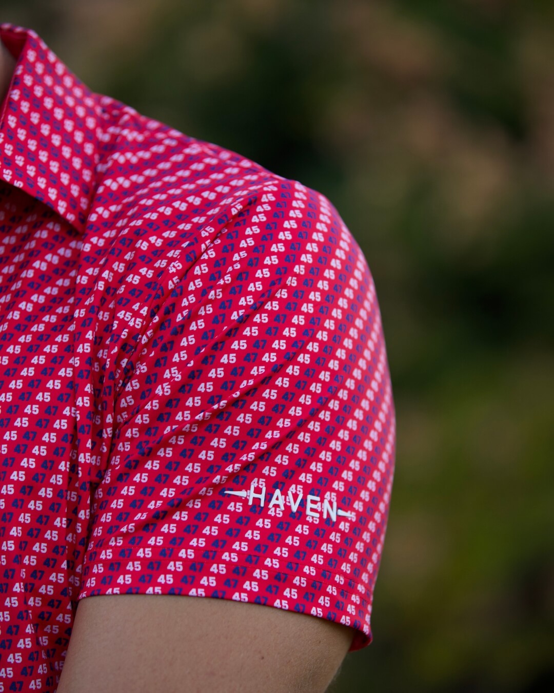 Close-up of The Don 45 polo shirt by Haven Golf, featuring a red pattern with white '45' motif for patriotic style.