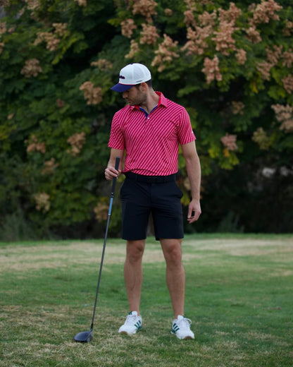 Golfer wearing 45 Polo Shirt – The Don by Haven Golf, standing on green with club, showcasing athletic fit and style for patriotic golfers.