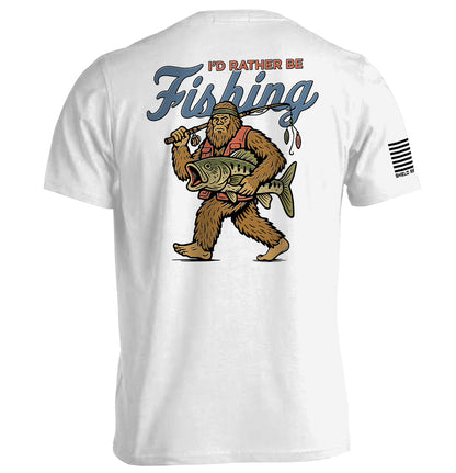 I’d Rather Be Fishing Bigfoot Shirt featuring Bigfoot with fishing rod and fish, humorous fishing graphic tee for anglers.