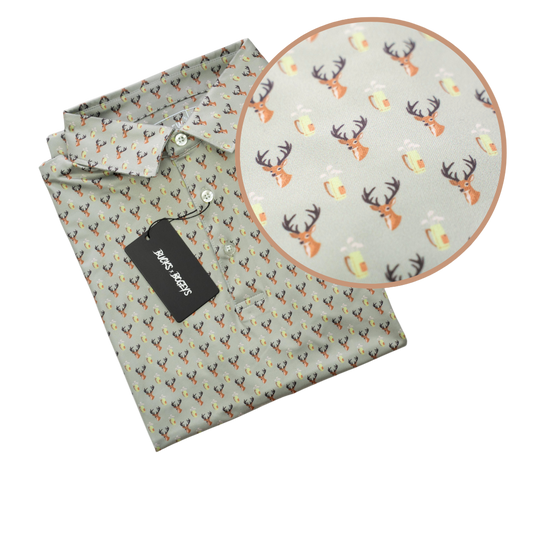 Folded shirt with a pattern of deer heads and antlers on a light green background, with a close-up inset showing the pattern.