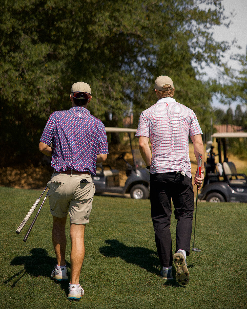 Golfers wearing 45 47 polo shirt by Haven Golf on a sunny course, displaying subtle patriotic style in red and navy print.