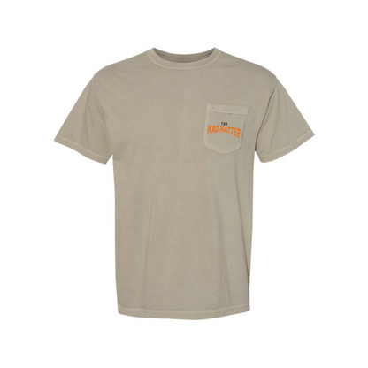Beige t-shirt with text "The Mad Hatter" on the pocket